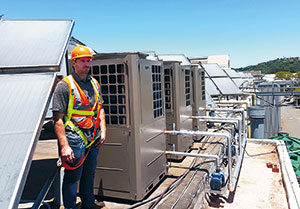 Shawn Marcus, Magnet Energy Wet Services, at a rooftop installation of heat pumps.